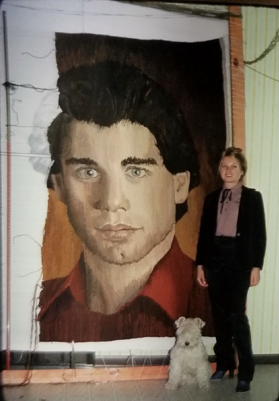 Lehman in front of tapestry of John Travolta